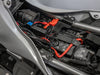 The adaptor fitted under a motorcycle side panel, wired to the battery terminals with its blue switch tucked against the frame